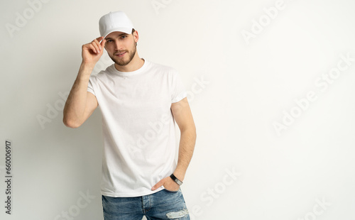 Handsome man wearing blank white cap and white t-shirt isolated on white background.