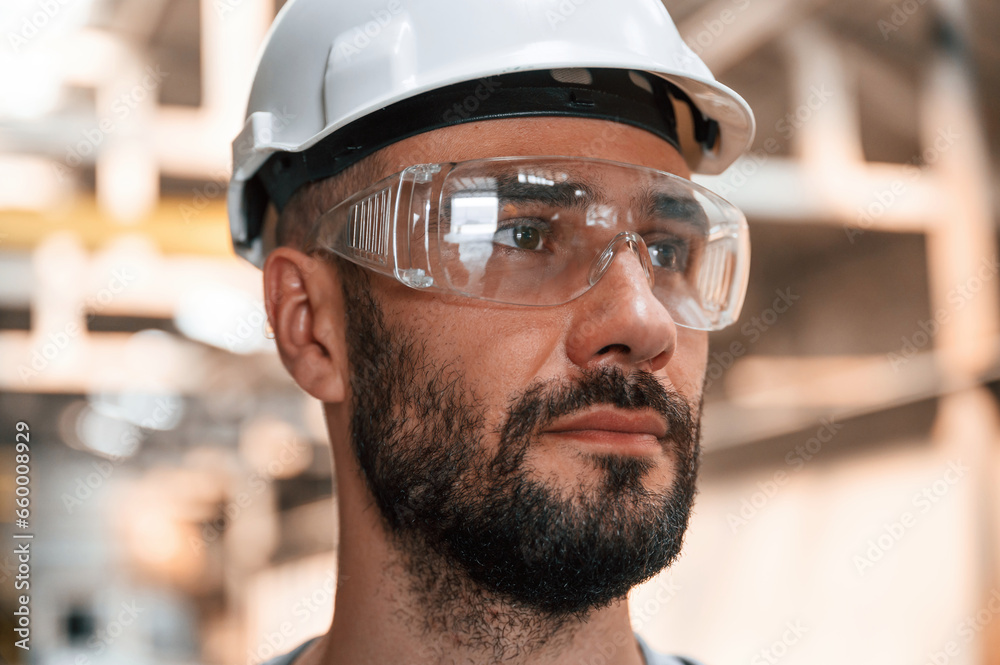 Beautiful portrait. Young factory worker in grey uniform Beautiful portrait. Young factory worker in grey uniform