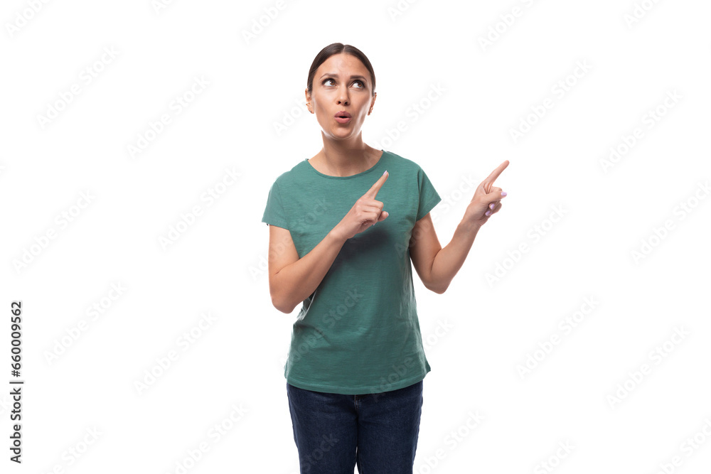 young charismatic black-haired woman with collected hair is dressed in a basic t-shirt and jeans pointing her finger up in surprise young charismatic black-haired woman with collected hair is dressed in a basic t-shirt and jeans pointing her finger up in surprise