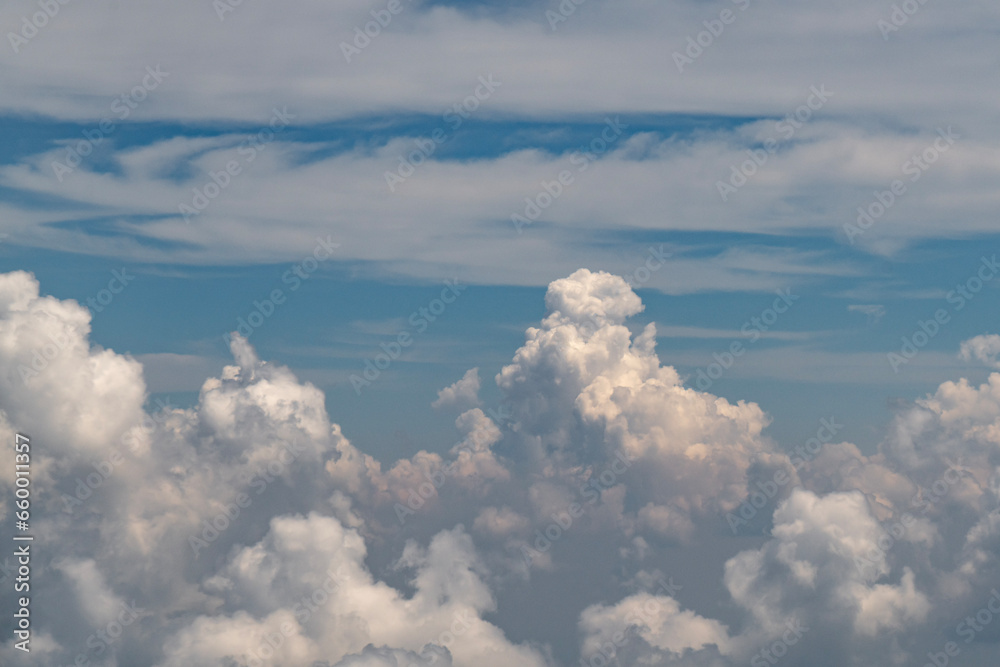 White fluffy clouds against a blue sky as seen from a plane
White fluffy clouds against a blue sky as seen from a plane