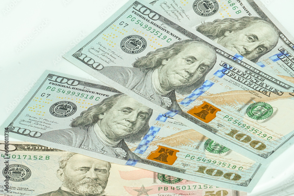 50 and 100 dollar bills of US in a white background 50 and 100 dollar bills of US in a white background