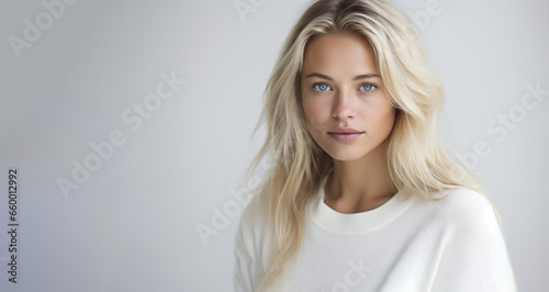 Beautiful Blonde Woman Wearing a White T-shirt against a White Background