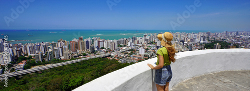Traveling in Brazil. Panoramic view of female tourist with hat in Vila Velha city, Greater Vitoria, Espirito Santo, Brazil. photo
