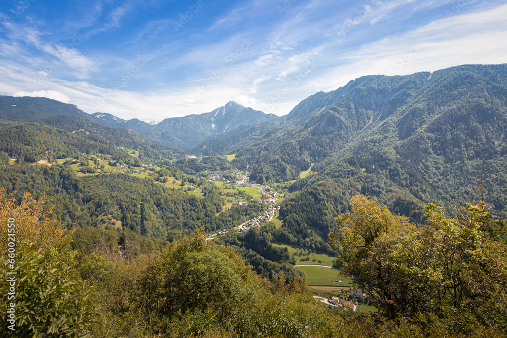 Mountain landscape with green forests and blue summer sky