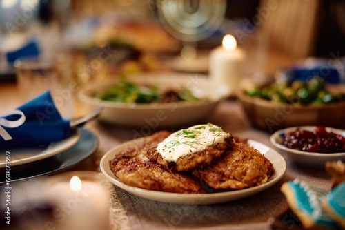 Potato latkes, traditional Jewish food on dining table during Hanukkah.
