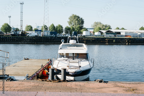 Fotografie Small boat moored on the pier, front view