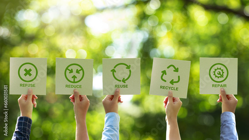 A group of businessmen's hands holding a brown recycled paper card with 5R sign and icon. Recycle, Reuse, Reduce, Refuse, and Repair for zero waste movement and technology ecology care. photo