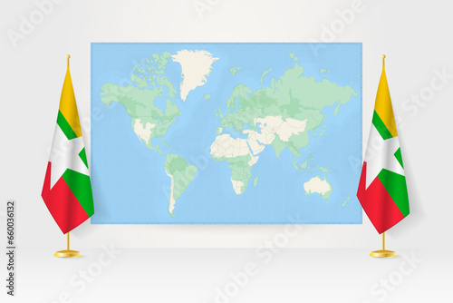 World Map between two hanging flags of Myanmar flag stand.