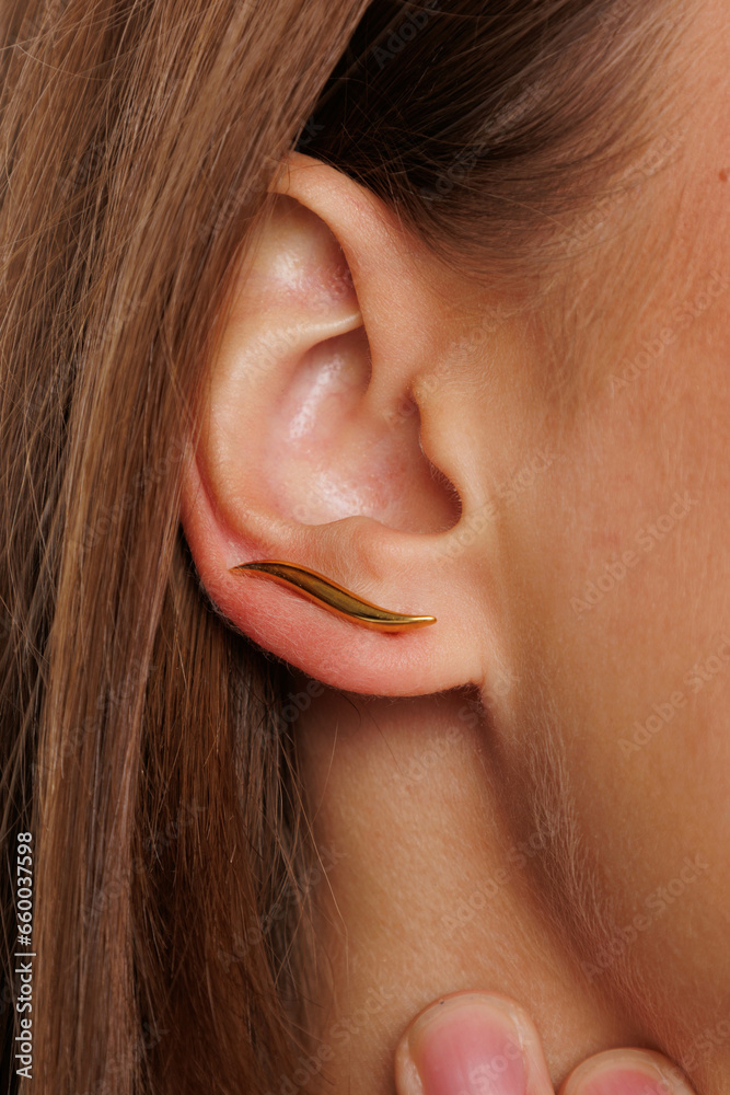 Beautiful young girl with fresh healthy skin. Woman advertise ear-rings. White background. Earrings, ear caffs closeup. Blond european woman with long hair with big lips, pretty smile. Cosmetology Beautiful young girl with fresh healthy skin. Woman advertise ear-rings. White background. Earrings, ear caffs closeup. Blond european woman with long hair with big lips, pretty smile. Cosmetology