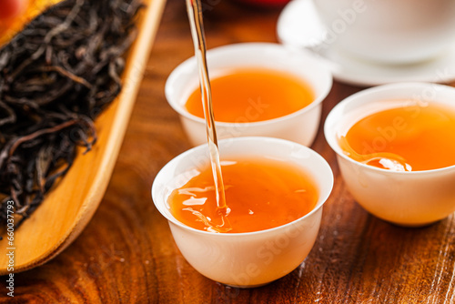 Brewing Chinese tea in ceramic gaiwan during the tea ceremony close-up.