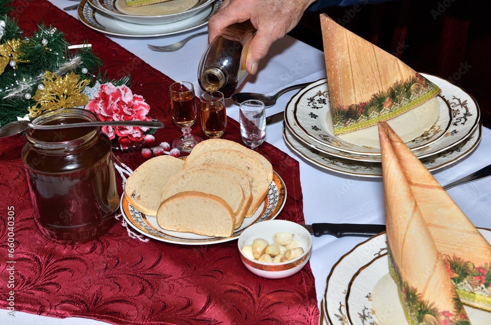 A festive toast with wafers, honey and garlic at the Christmas table