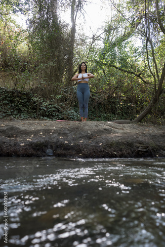 Woman doing yoga in the river