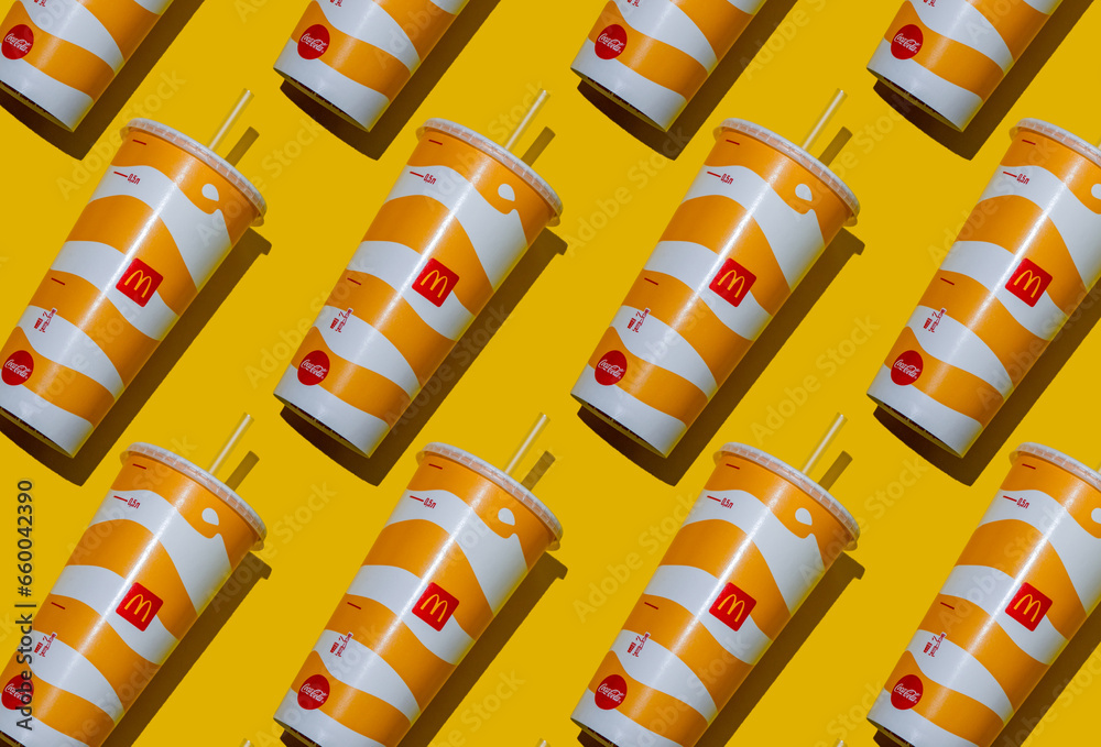 Yellow glass of McDonald's. Paper cup with lid. Takeaway drink ...