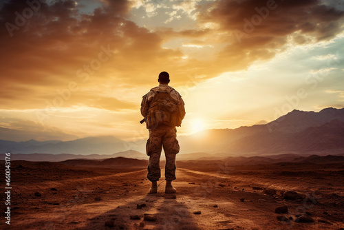 Against a breathtaking desert sunrise, a soldier in uniform stands in silhouette, the promise of a new day bringing hope and resolve to their military duties in the arid landscape. 