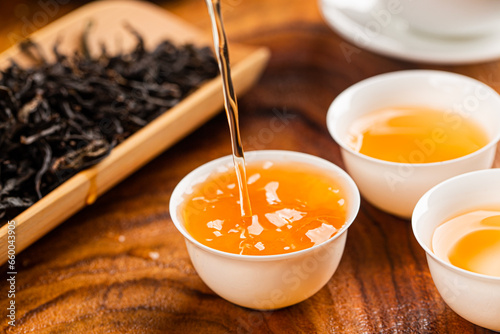 Brewing Chinese tea in ceramic gaiwan during the tea ceremony close-up.