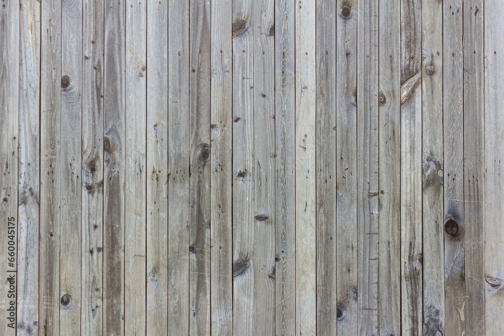 Old wooden background made of thin boards. The old wooden wall darkened with time, with many nails. Old wooden background made of thin boards. The old wooden wall darkened with time, with many nails.