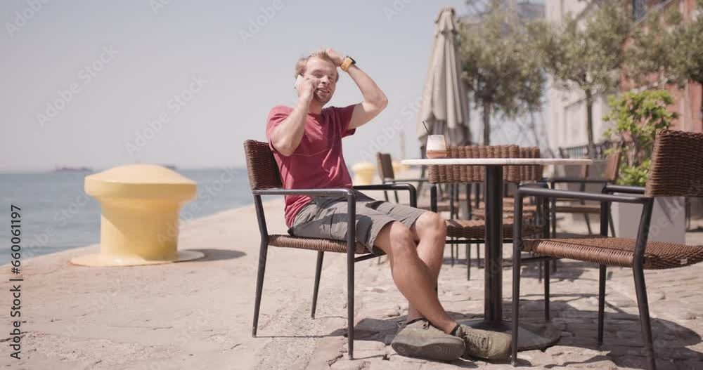 custom made wallpaper toronto digitalMale tourist having drink at a cafe in a city near the sea port. Man on a coffee break talking on phone and checking the time.