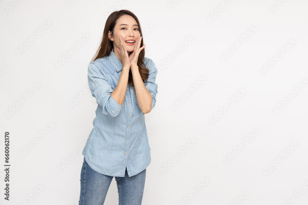Asian woman wearing jeans shirt with open mouths raising hands screaming announcement isolated on white background Asian woman wearing jeans shirt with open mouths raising hands screaming announcement isolated on white background