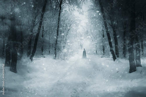 mysterious cloaked silhouette on snowy forest road  fantasy winter landscape