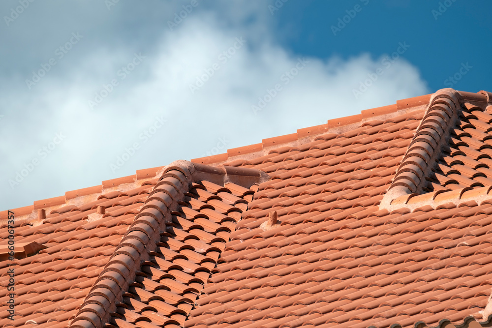 Overlapping rows of yellow ceramic roofing tiles covering residential building roof in southern Florida Overlapping rows of yellow ceramic roofing tiles covering residential building roof in southern Florida