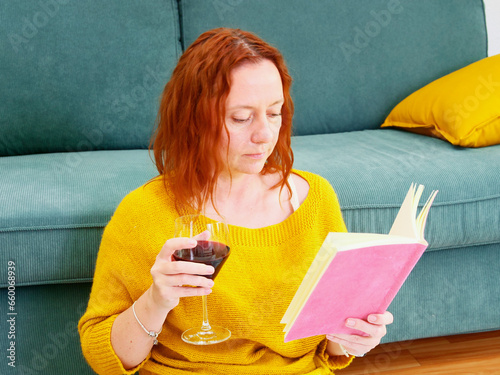 Obraz na płótnie Woman relaxing at home, reading diary or book with the glass of wine w salonie
