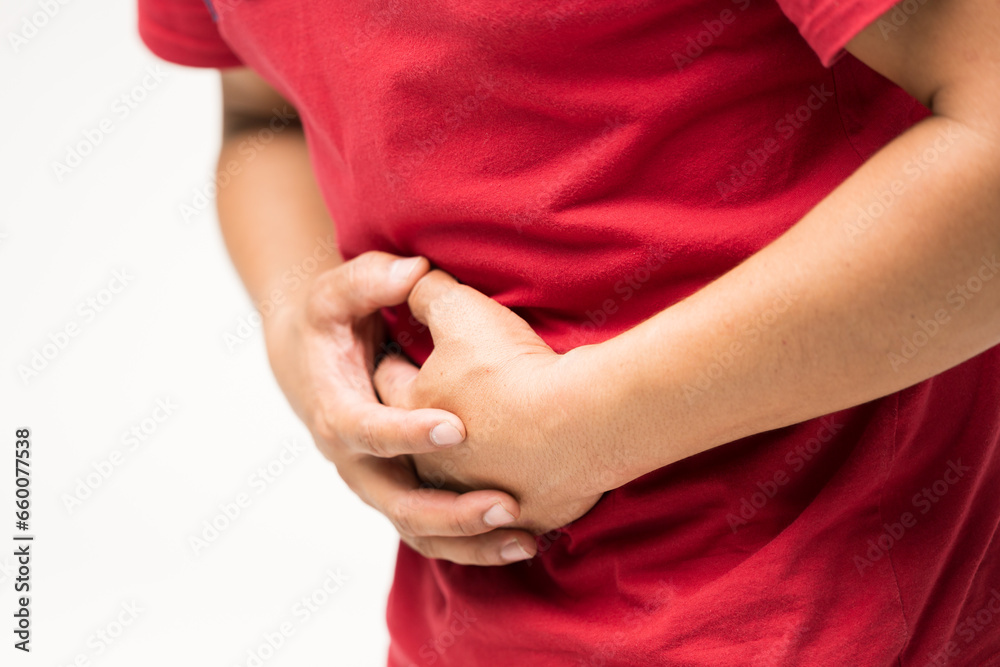 A man hand touching on stomach symptom of stomachache or stomach pain with copy space. Stomach pain and others abdominal disease.Man hand palm around waistline to show pain and injury on belly area. A man hand touching on stomach symptom of stomachache or stomach pain with copy space. Stomach pain and others abdominal disease.Man hand palm around waistline to show pain and injury on belly area.