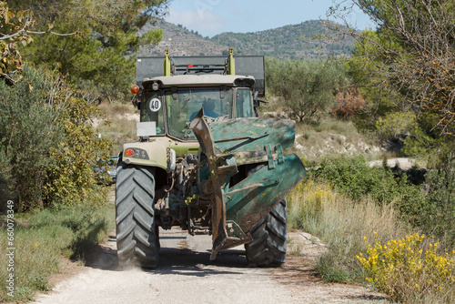 Tractor equipado con maquinaria de vuelta a casa despues de un duro dia de trabajo, Gaianes, España photo
