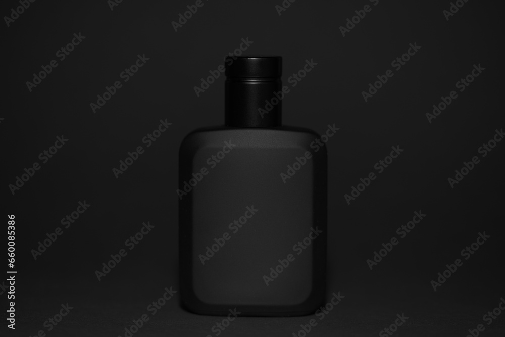 Macro photography of black perfume bottle isolated on black background
