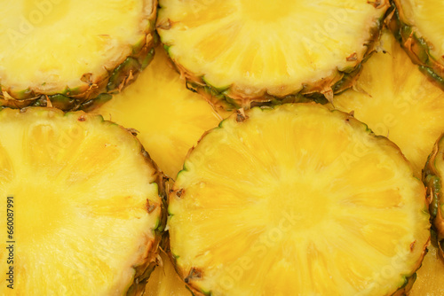 Pineapple juicy yellow slices as a background.