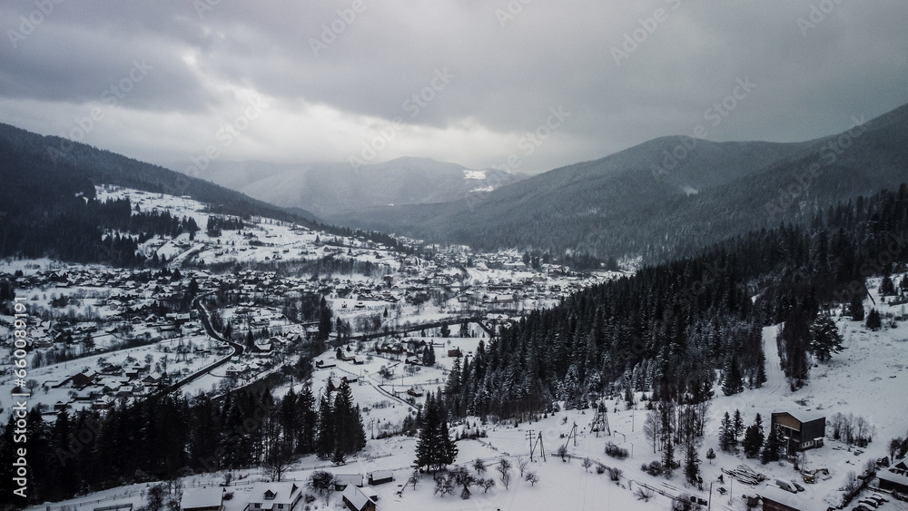 Aerial View of idyllic high-rise touristic place in Carpathian Mountains, foggy weather, winter season