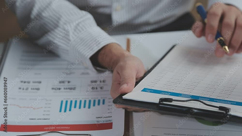 Group of confident business people point to graphs and charts to analyze market data, balance sheet, account, net profit to plan new sales strategies to increase production capacity. Group of confident business people point to graphs and charts to analyze market data, balance sheet, account, net profit to plan new sales strategies to increase production capacity.