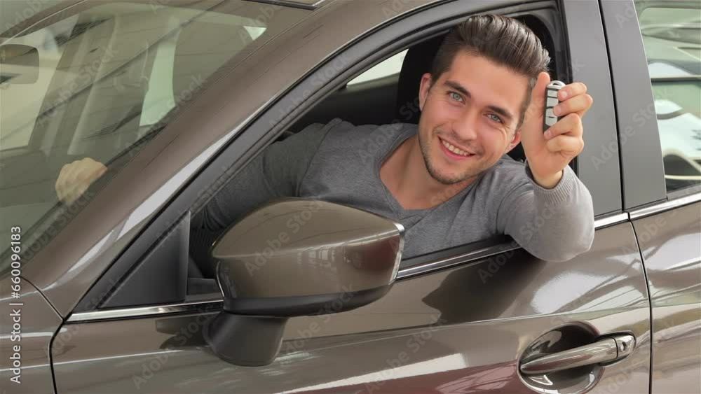 Man showing the key of his new car Man showing the key of his new car