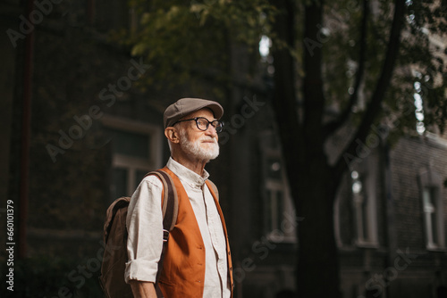 Senior tourist exploring new city, exploring interesting places. Elderly man with beret. Traveling and trips in retirement.