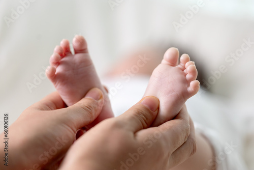 신생아의 발을 마사지하는 엄마의 손 photo