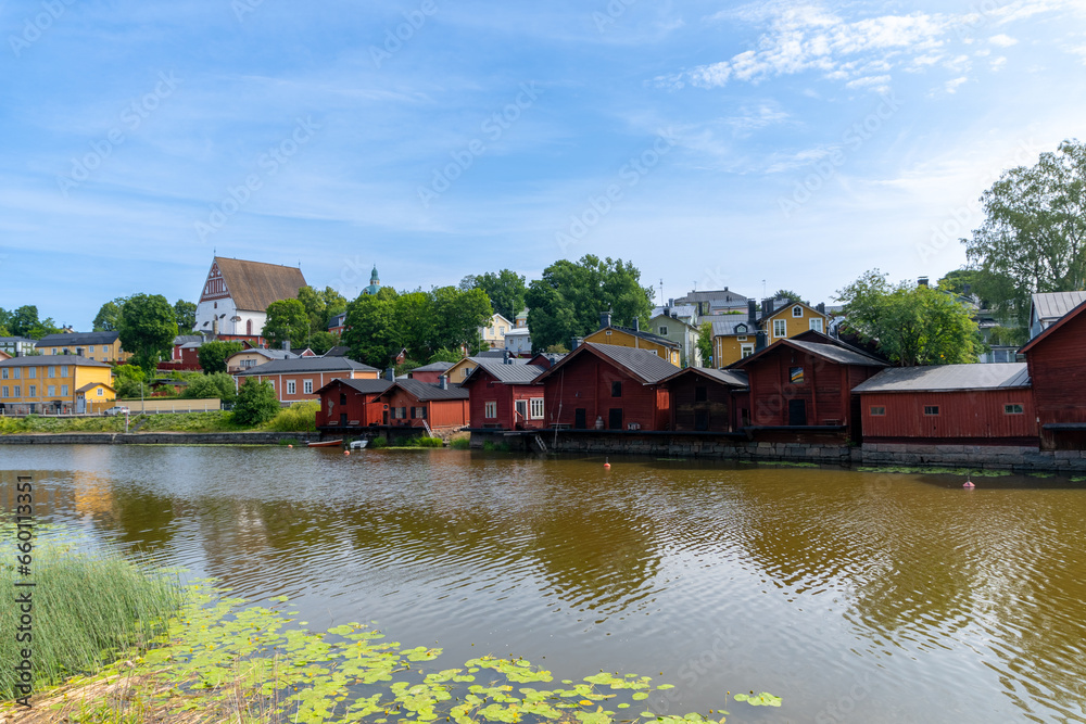 Panoramic view of the city of Porvoo in Finland. Little red houses next to the river. Day with clouds in the sky.