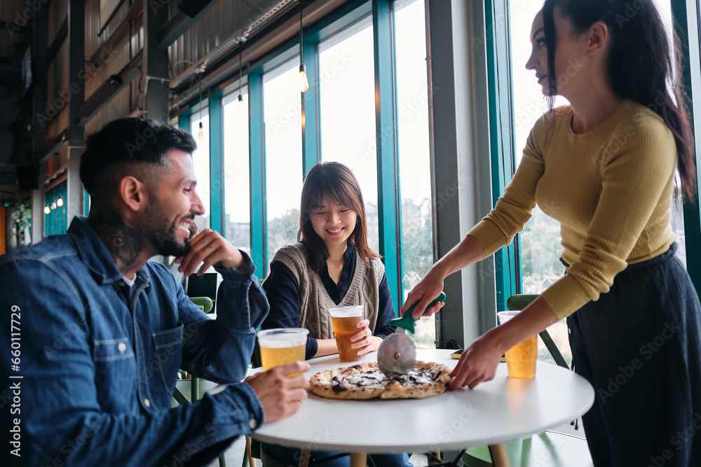 Group of Friends Having Pizza in a restaurant Group of Friends Having Pizza in a restaurant