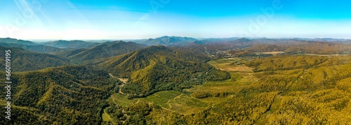 the valley of the Shapsukho River near the village of Defanovka and the Black Sea on the horizon (Western Caucasus, South Russia) on a sunny day in early autumn - aerial panorama