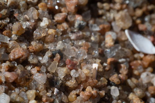 Macro photo of small quartz sand particles at a beach.