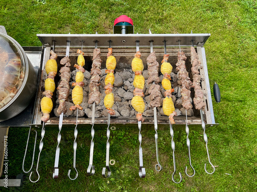 Automatic roasted meat cooked at barbecue with smoke photo