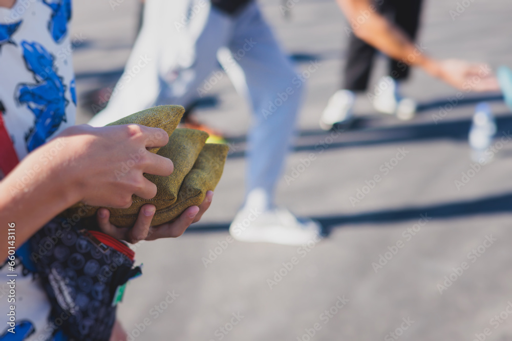 Cornhole game set, process of throwing bean bags, kids children tossing ...
