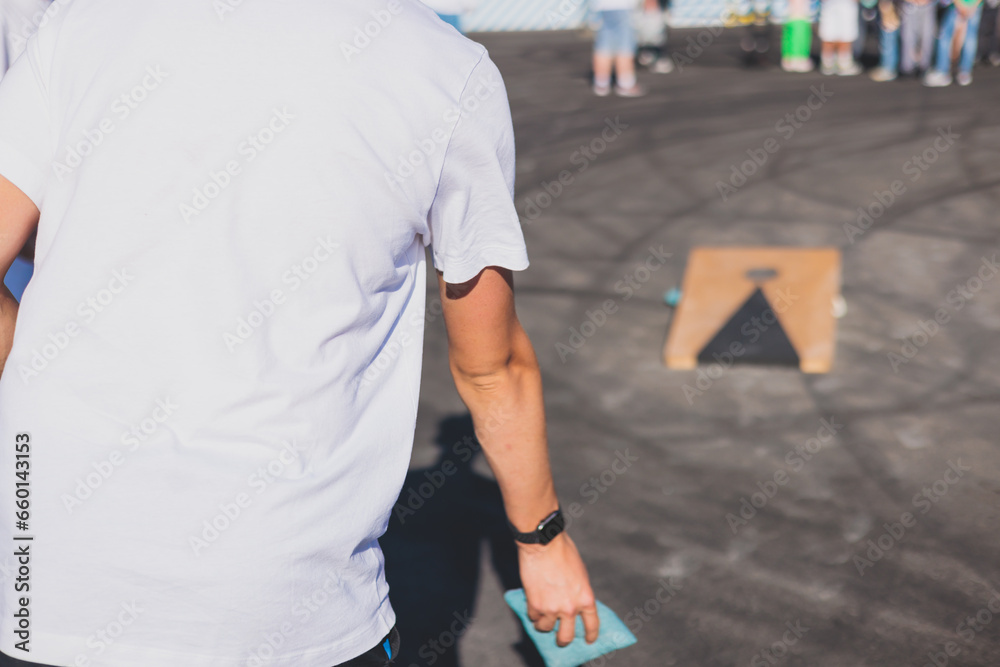 Cornhole game set, process of throwing bean bags, kids children tossing ...