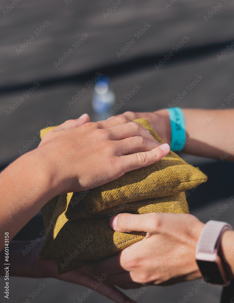 Cornhole game set, process of throwing bean bags, kids children tossing ...