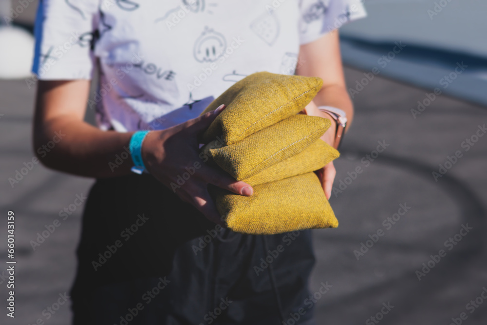 Cornhole game set, process of throwing bean bags, kids children tossing ...