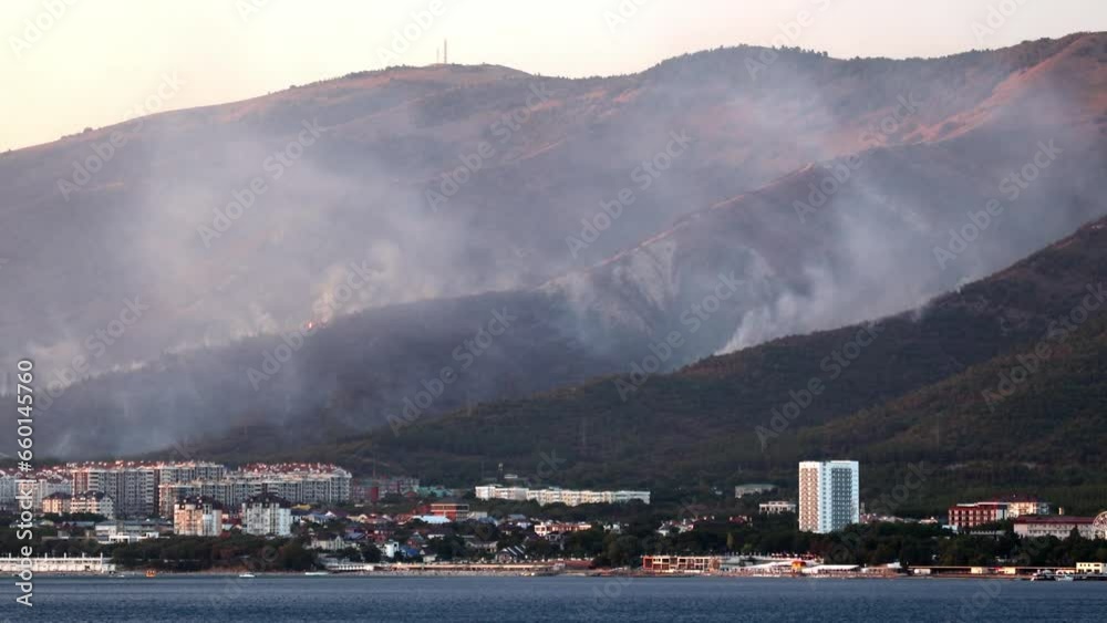 Forest fire in the mountains. Wild fire and smoke. Helicopters drop water on the fire and extinguish the fire. A natural disaster in the Caucasus Mountains on the Black Sea coast. Gelendzhik Resort Forest fire in the mountains. Wild fire and smoke. Helicopters drop water on the fire and extinguish the fire. A natural disaster in the Caucasus Mountains on the Black Sea coast. Gelendzhik Resort