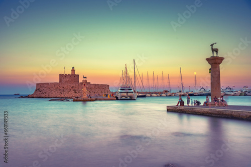 Mandraki port with deers statue, where The Colossus was standing and fort of St. Nicholas. Rhodes, Greece. 