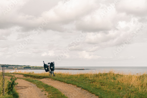  Traveller on bicycle. Solo travel long distance bicycle touring concept