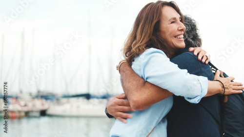 Elderly man meets his girlfriend on the promenade, hugging joing meeting photo