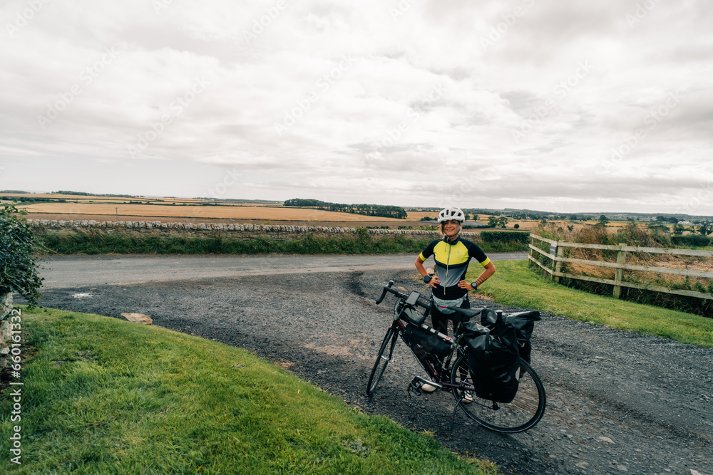 Obraz premium Traveller on bicycle. Solo travel long distance bicycle touring concept