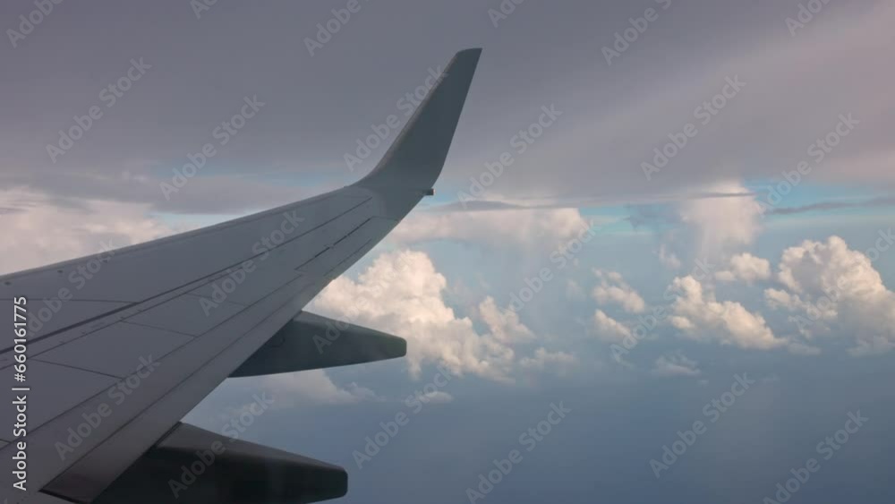 Rainbow in cloudy blue sky beneath wing of flying aircraft. Rainbow in cloudy blue sky beneath wing of flying aircraft.