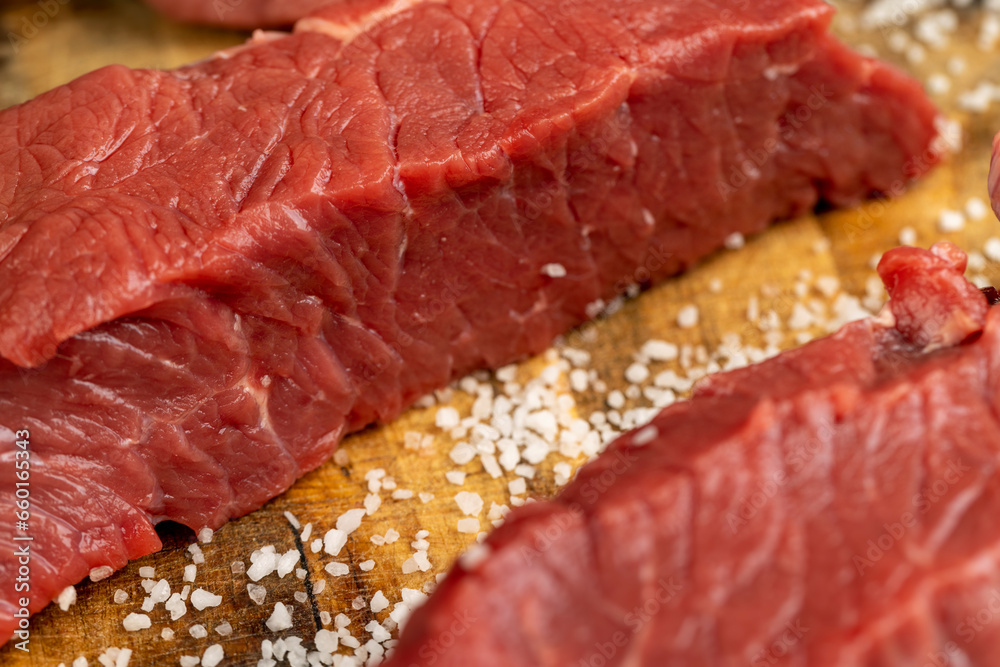 sliced piece of fresh raw beef during salting